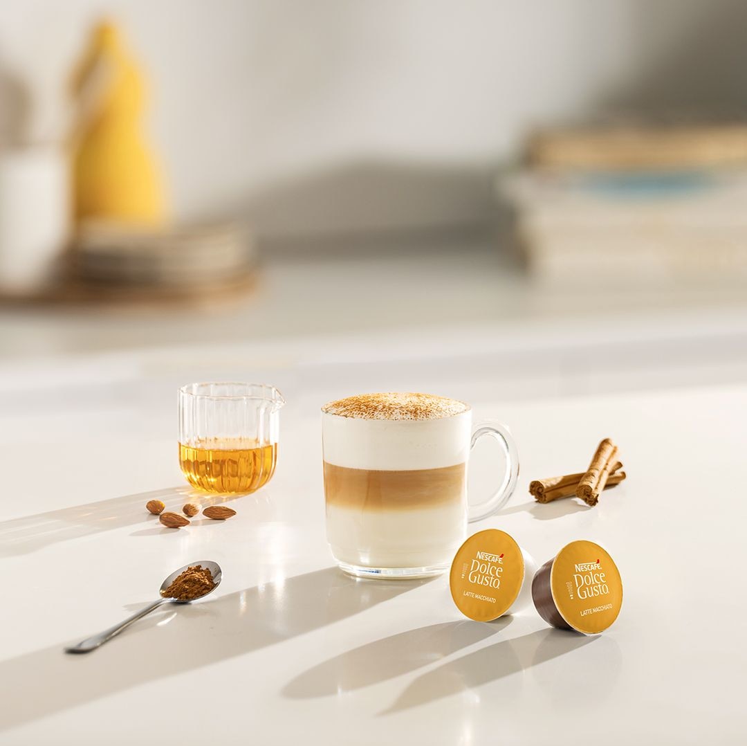 iced cappuccino next to a coffee capsule